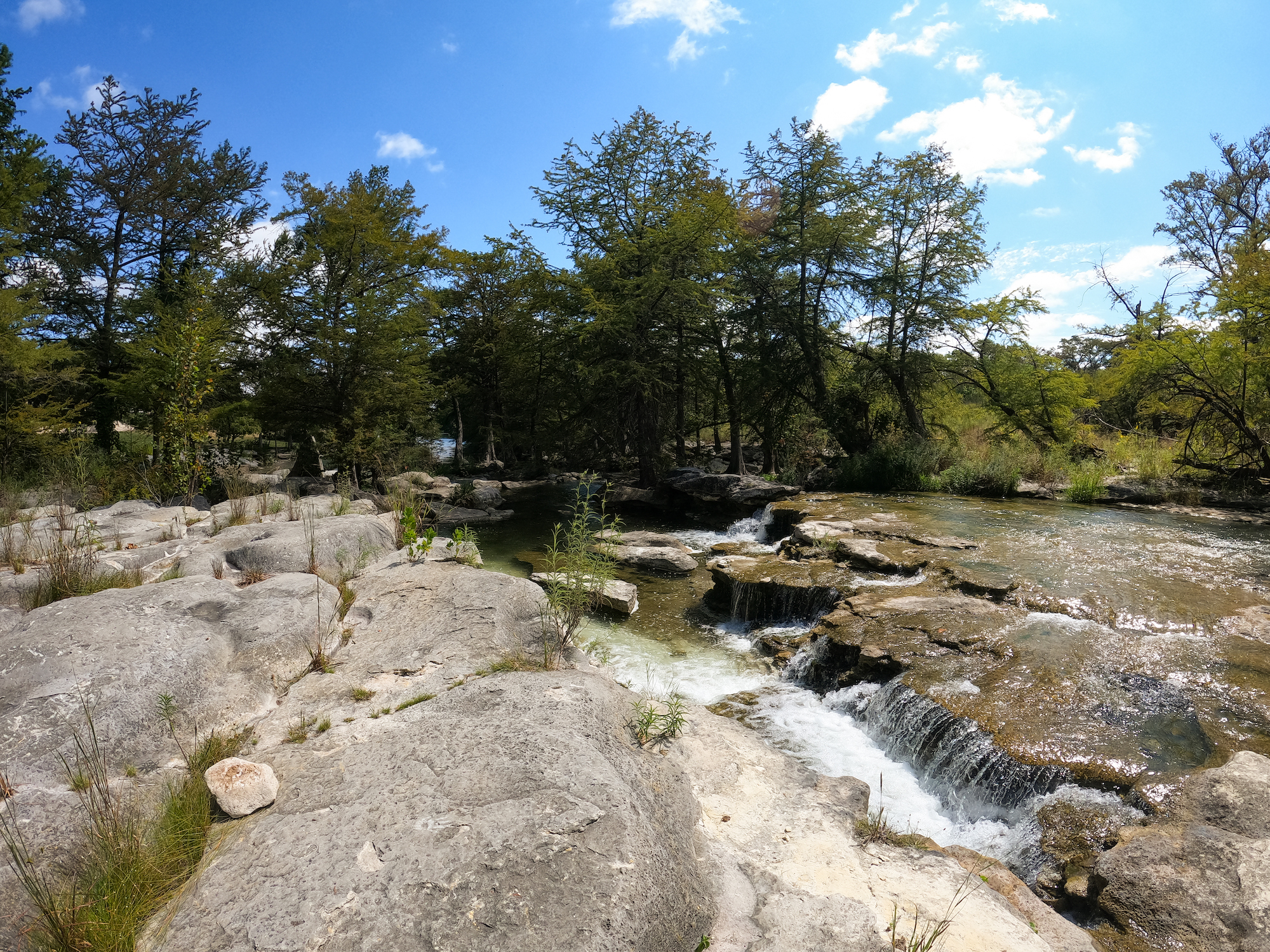 The Guadalupe River flowing over rocks near Basecamp Resort
